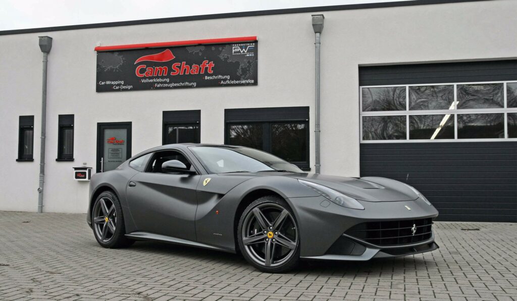 Sleek Black Ferrari F12 Berlinetta: Stylish Side View Wallpaper
