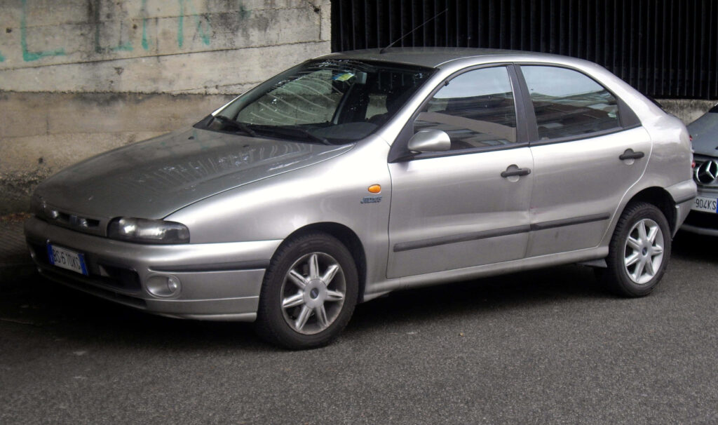 Fiat Bravo Urban Wallpaper: Timeless Design Against Rustic Wall