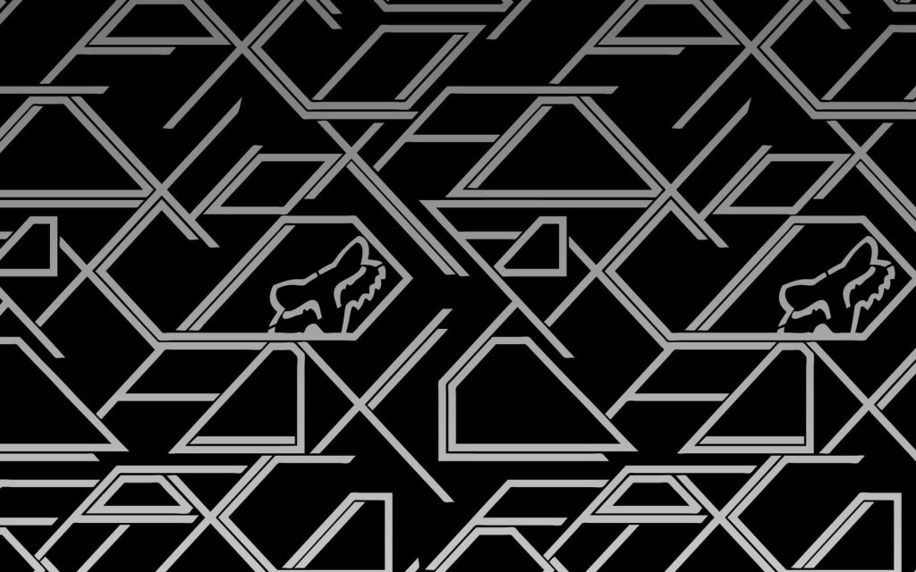 Sleek Fox Racing wallpaper with silver geometric Fox Head logo on deep black motocross background