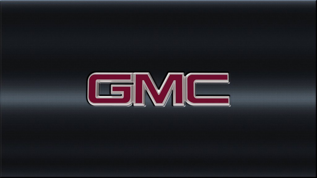 Sleek GMC logo on dark textured metallic grid background automotive wallpaper desktop design