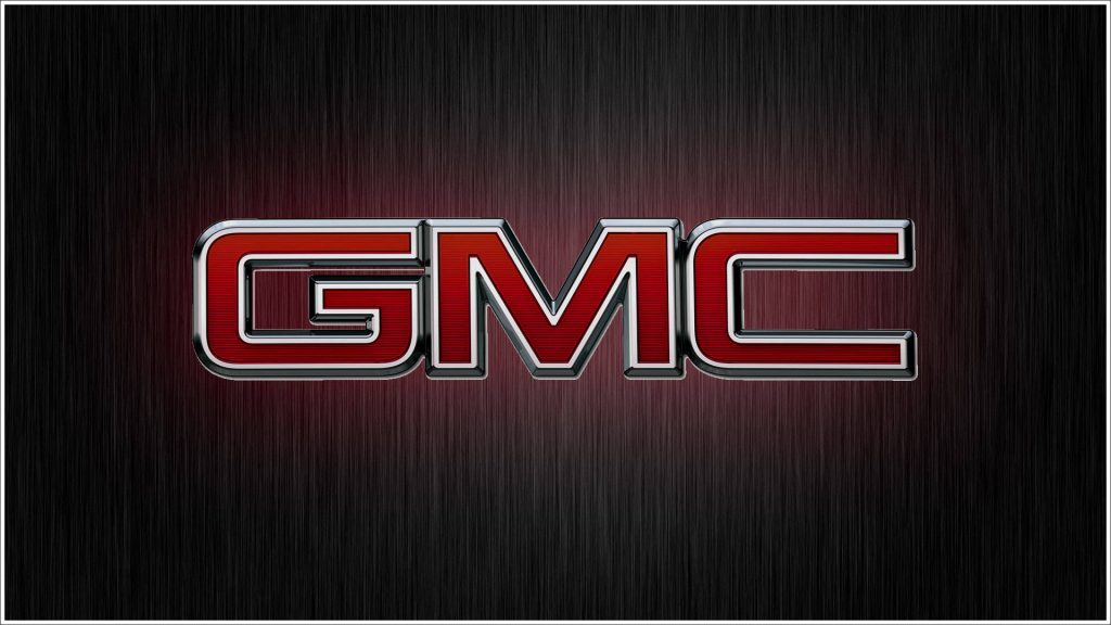 Sleek GMC logo wallpaper on dark brushed metal background minimalist automotive design