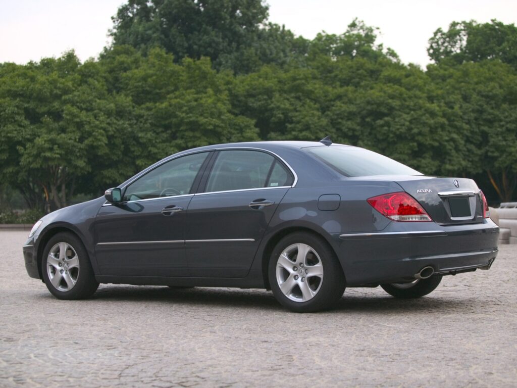 Sleek Gray Acura RL Side View Wallpaper on Asphalt with Green Trees