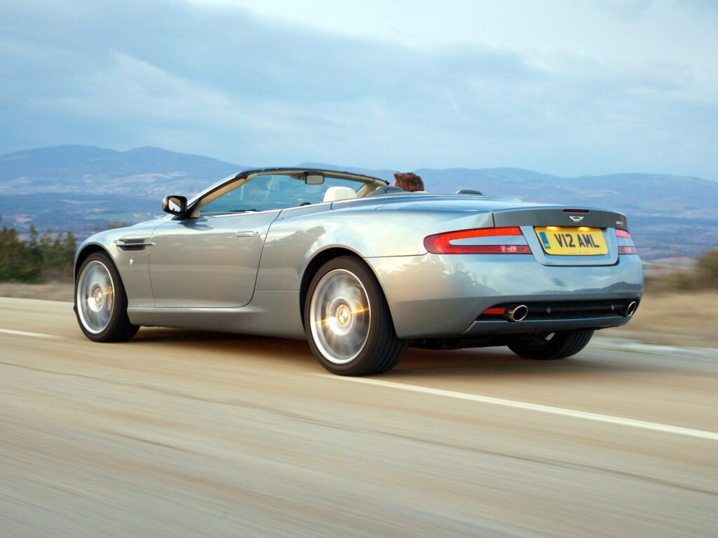 Sleek Gray Aston Martin DB9: 2004 Model in Scenic Mountain Drive Wallpaper