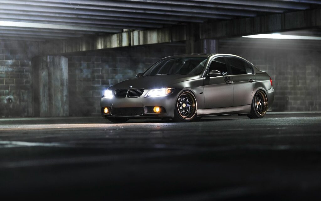Sleek Gray BMW 3 Series Side View in Moody Industrial Setting Wallpaper