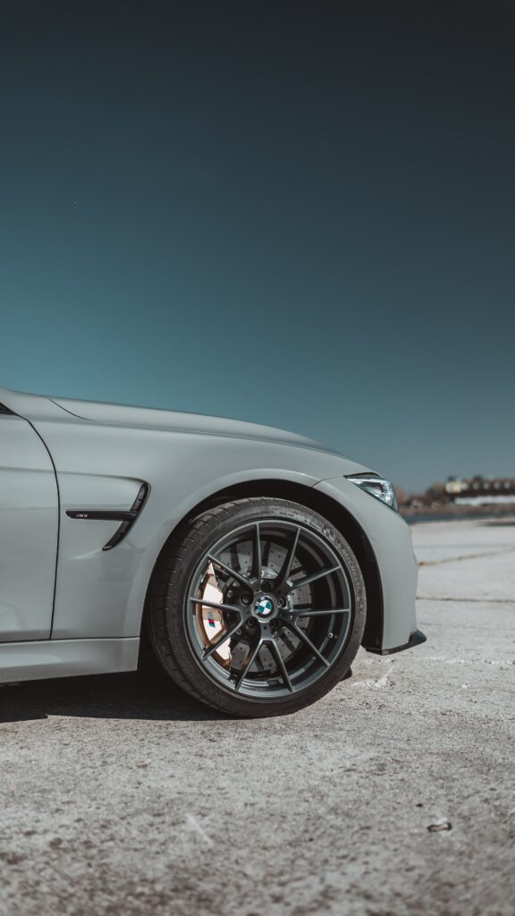 Sleek Gray BMW Wallpaper: Stylish Side View against Clear Sky