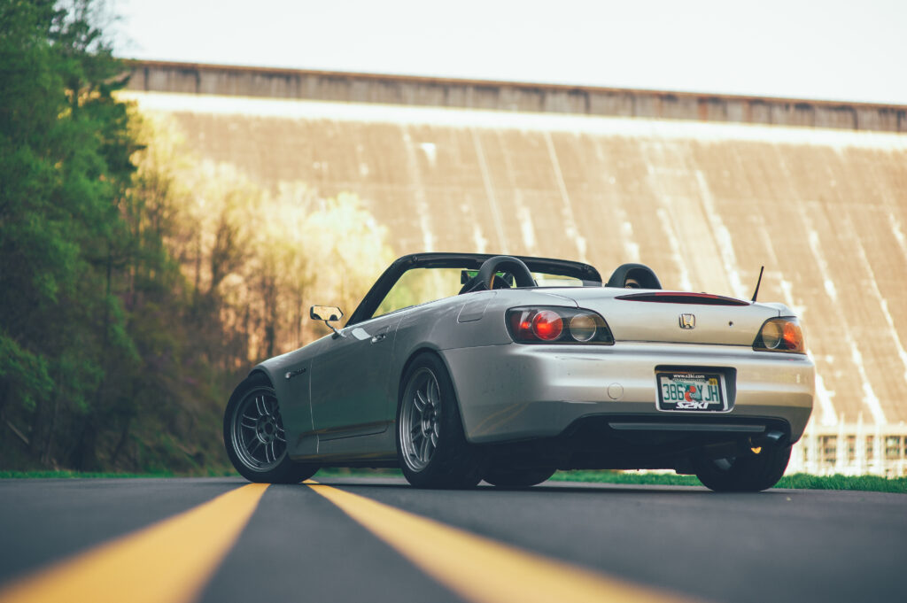 Sleek Gray Honda S2000 Convertible in Scenic Greenery Background Wallpaper