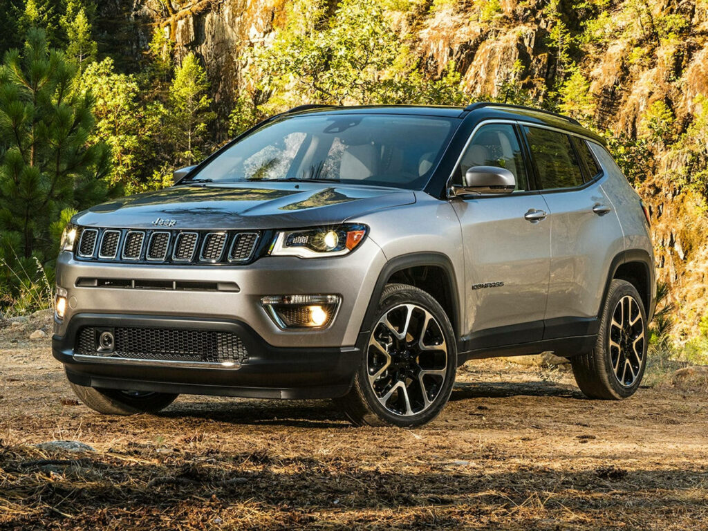 Gray Jeep Compass on rugged forest path showcasing adventure and modern SUV design wallpaper