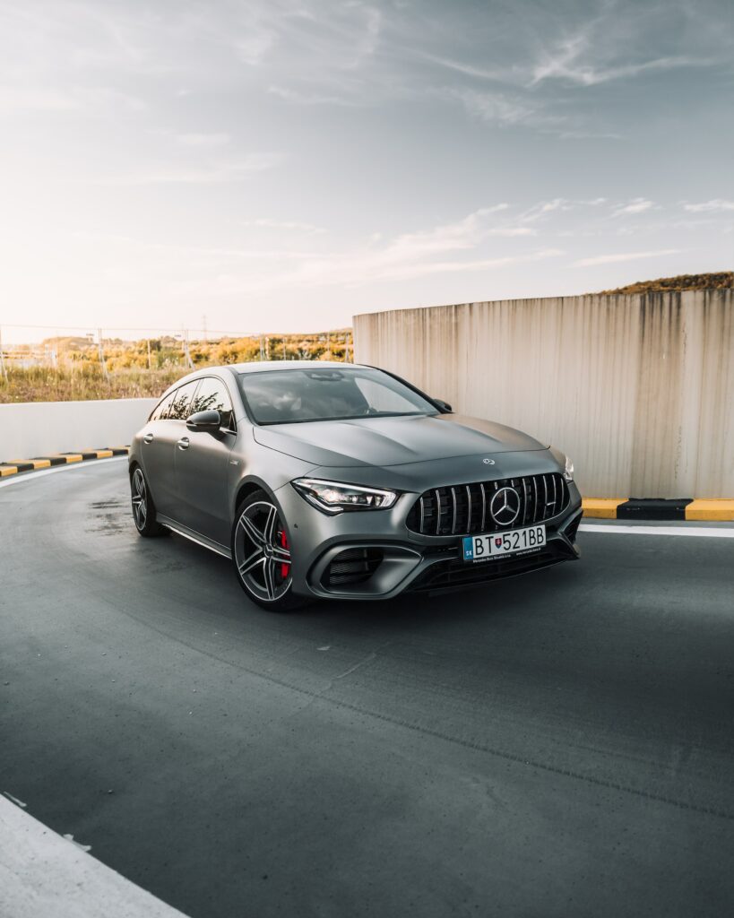 Elegant Gray Mercedes-Benz Wallpaper: Dynamic Side View on Smooth Road