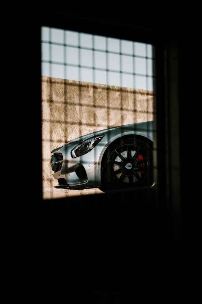 Sleek Gray Mercedes Wallpaper: Elegant Car Against Textured Wall