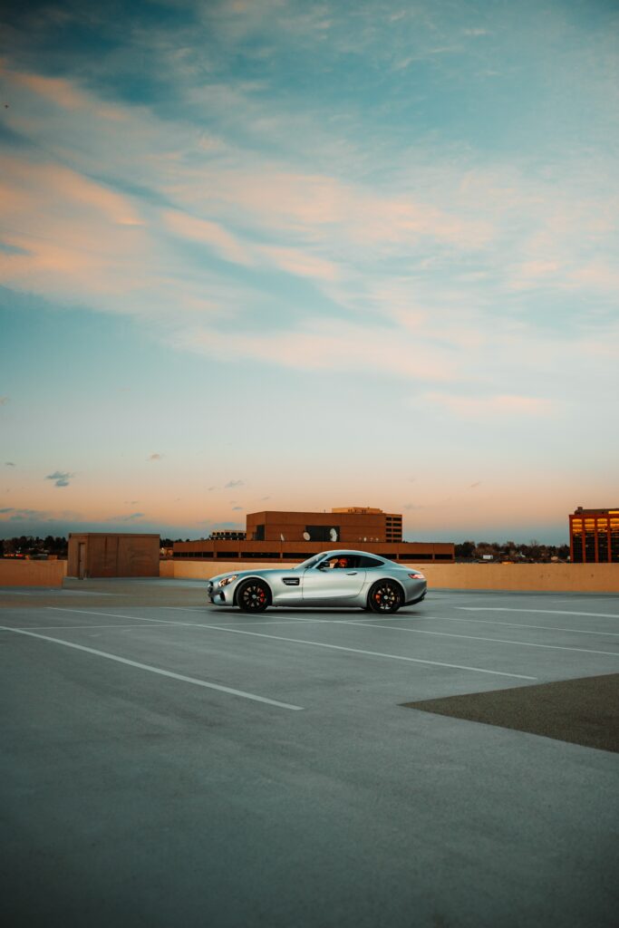 Sleek Gray Mercedes in Urban Parking Lot with Modern Building Background Wallpaper