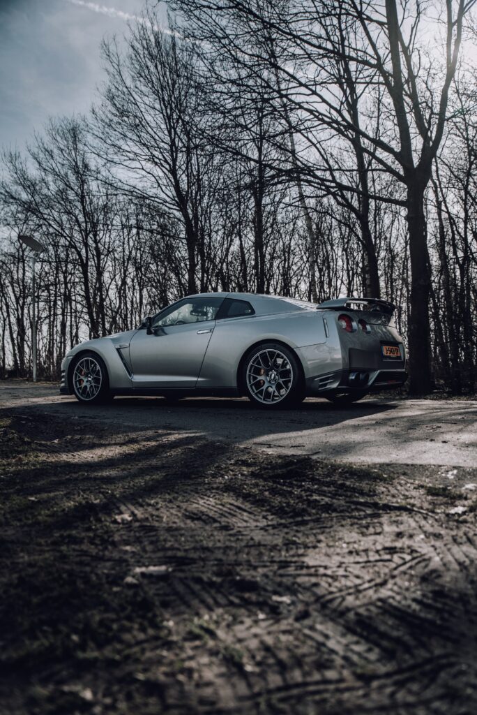 Sleek Gray Nissan GT-R Wallpaper: Serene Road and Bare Trees