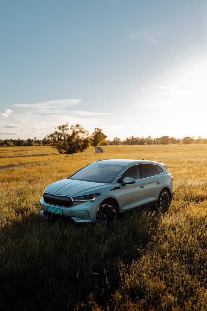 Sleek Gray Skoda Car in Serene Sunlit Field - Elegant Wallpaper