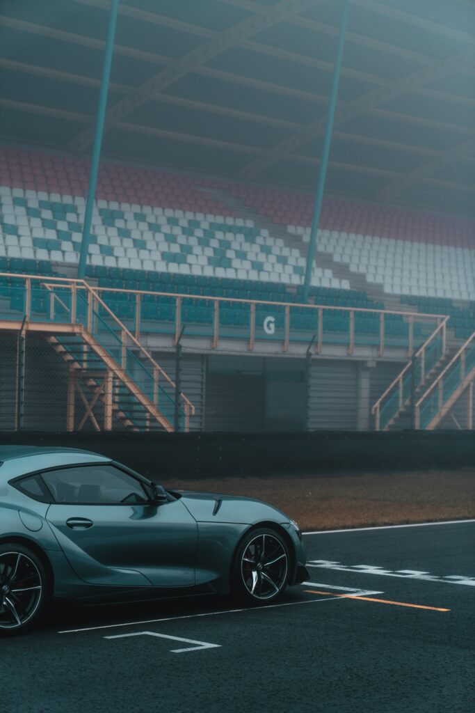 Sleek Gray Sports Car on Racetrack with Moody Atmosphere Wallpaper