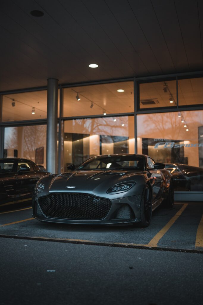 Sleek Gray Sports Car Wallpaper: Front View in Showroom Highlights