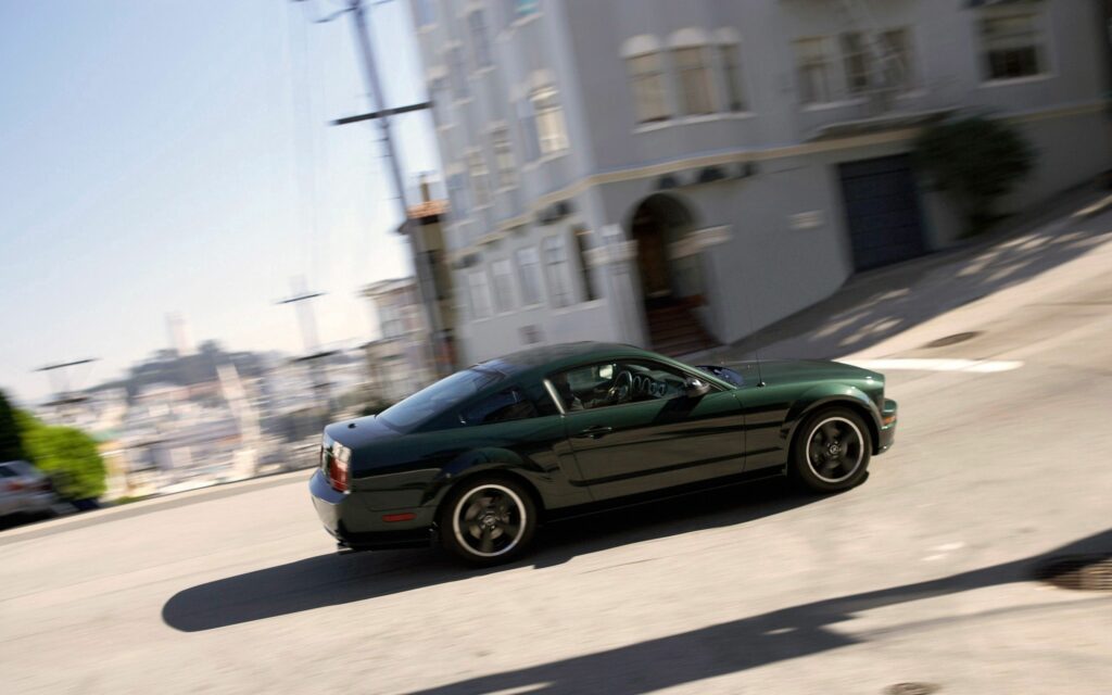 Green Ford Mustang in Motion: Urban Wallpaper for Car Lovers