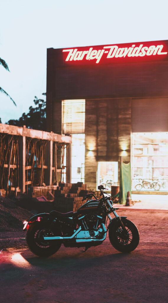 Sleek Harley Davidson: Vibrant Neon Sign Mobile Wallpaper Background