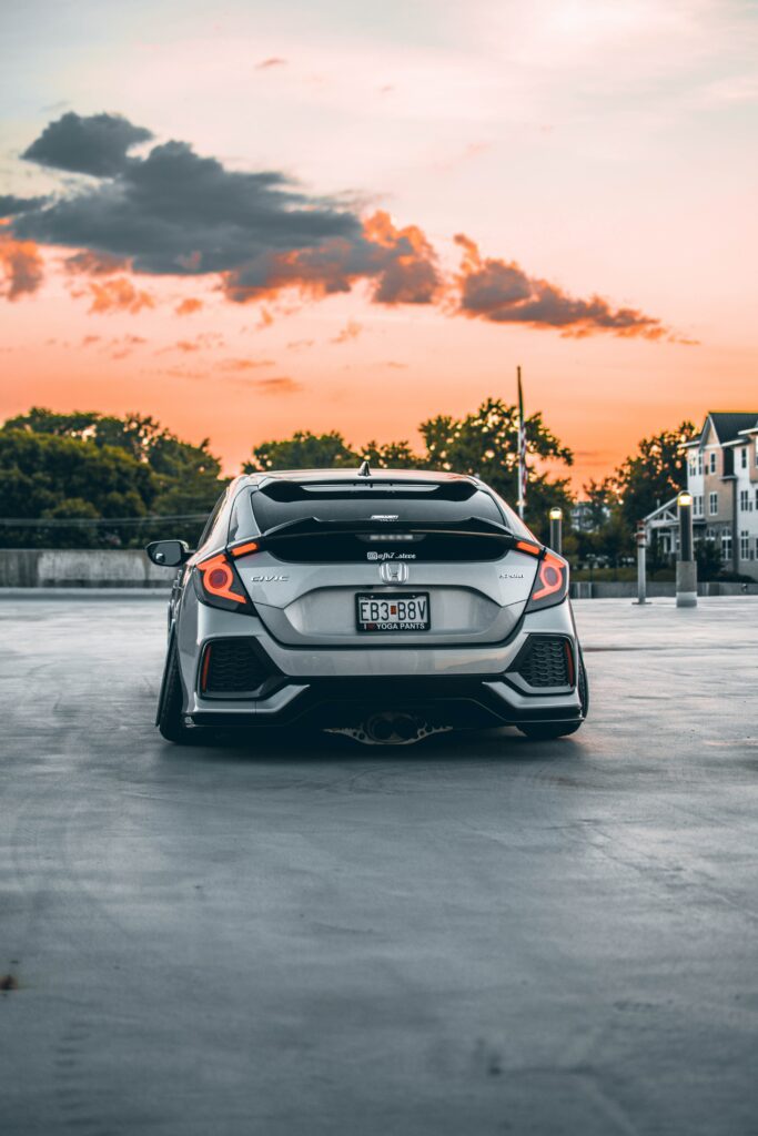 Sleek Honda Civic Sport: Rear View with Sunset Background Wallpaper