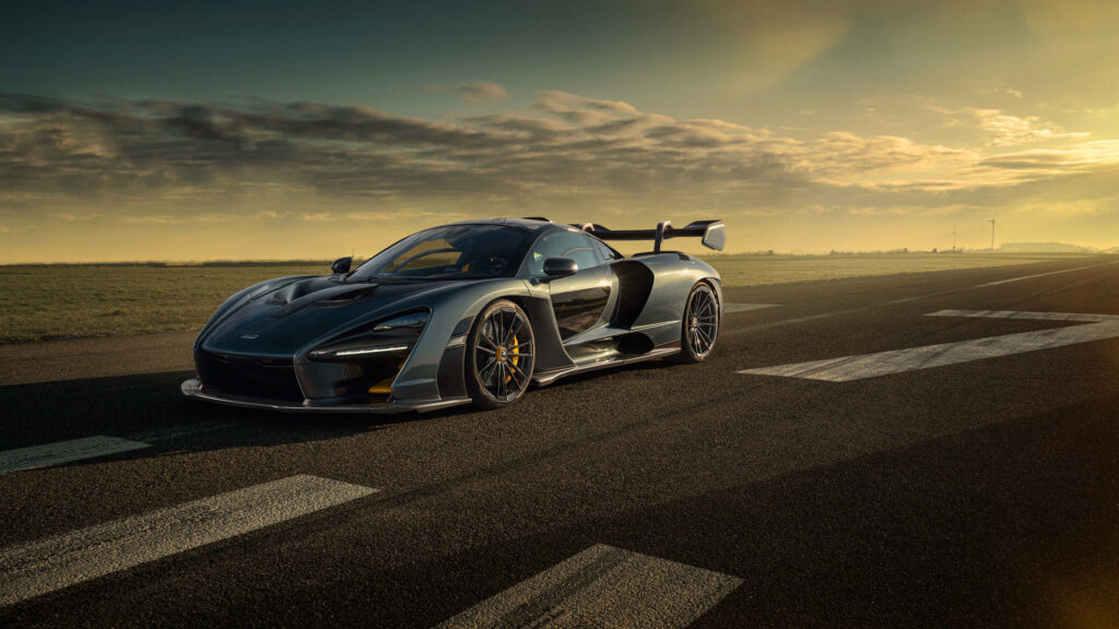 Hypercar on runway at sunset showcasing aerodynamic design and high-performance features Wallpaper