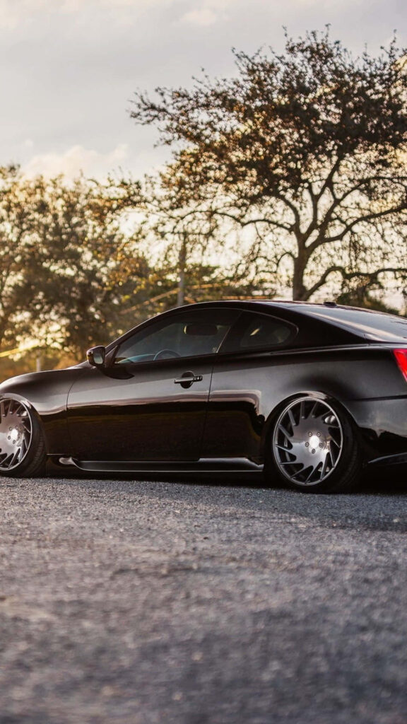 Stylish Infiniti G35 Wallpaper: Glossy Black Sports Car on Open Road