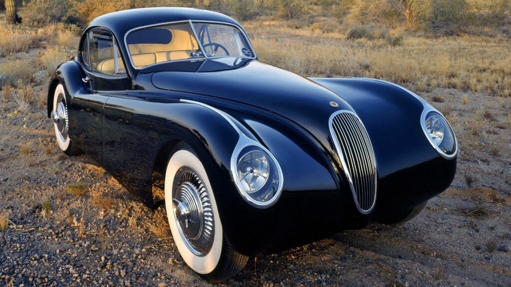Elegant Jaguar Wallpaper: Retro Car in Scenic Nature Background