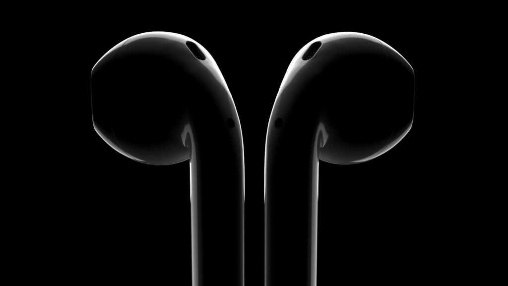 Jet black AirPods earbuds on dark background showcasing sleek modern minimalist wireless design Wallpaper
