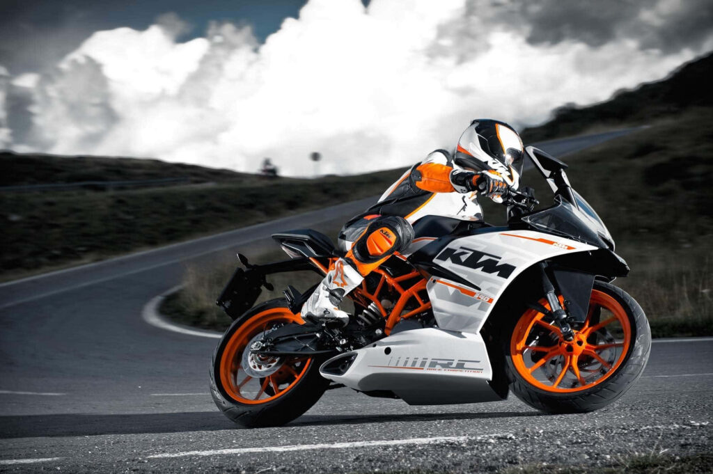Sleek KTM Bike Wallpaper: Adventure on a Scenic Curving Road