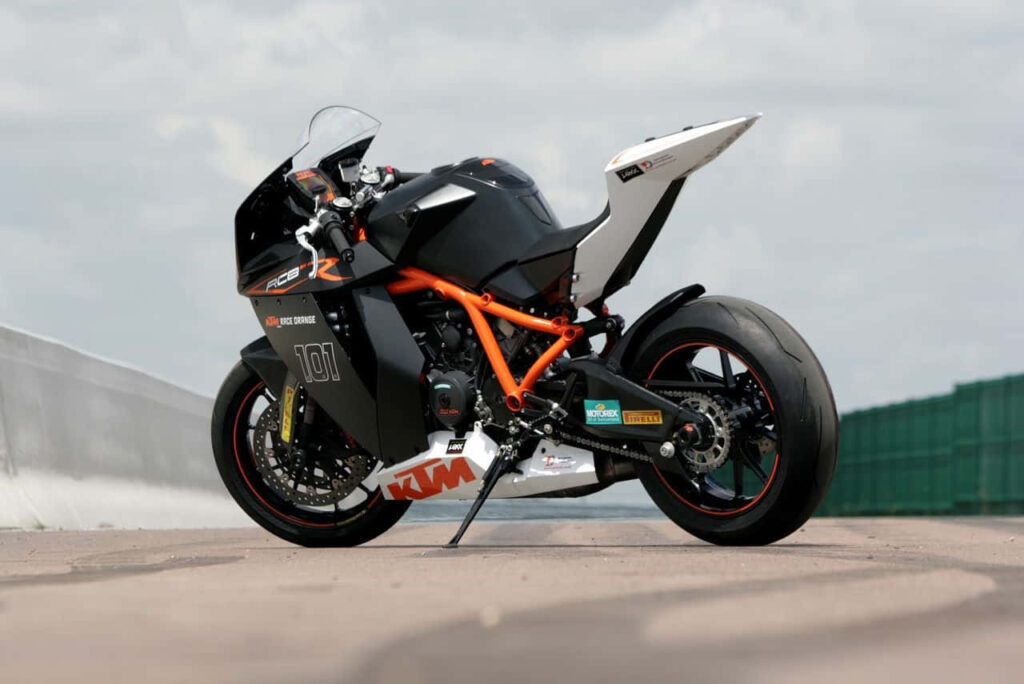 Dynamic KTM Bike Wallpaper: Sporty Black & Orange Design on Track