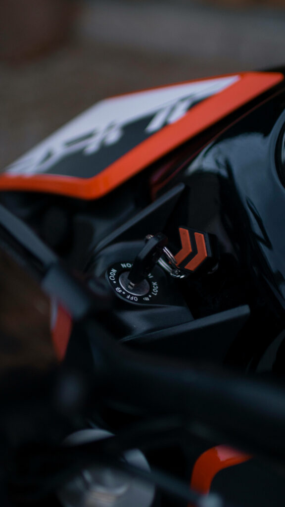 Sleek KTM Ignition Switch Wallpaper: Black & Orange Design
