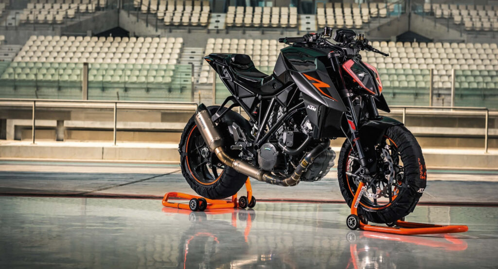 Sleek KTM Motorbike Wallpaper in Modern Stadium Setting