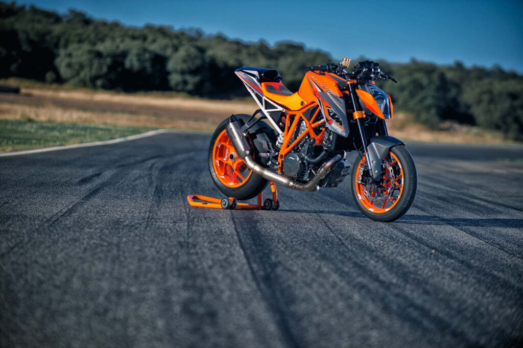 Vibrant KTM Motorbike Wallpaper on Racetrack – Bold & Sleek Design