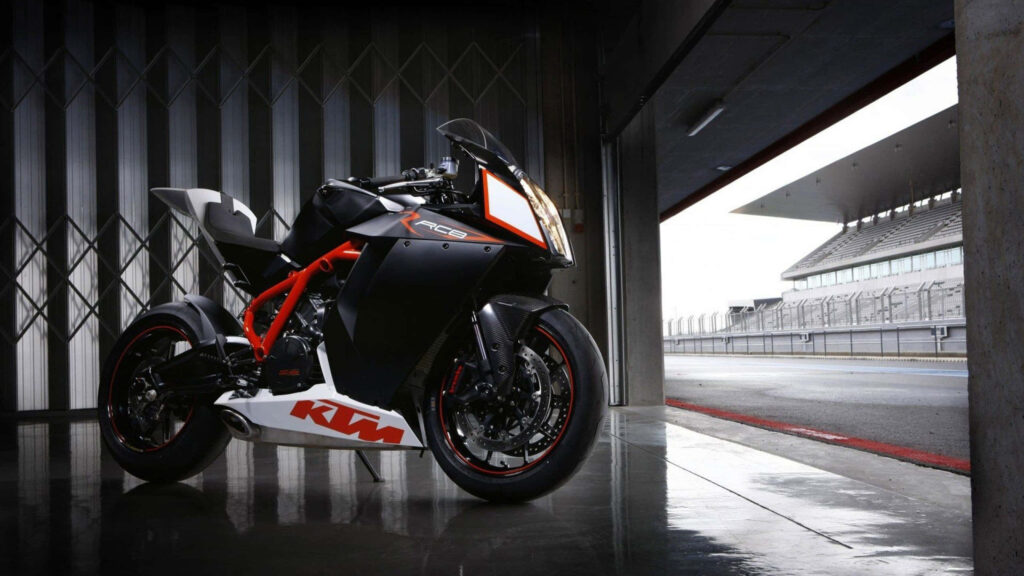 Sleek KTM RC8 Motorbike Wallpaper in Modern Garage Setting
