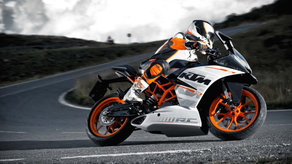 Sleek KTM Sports Bike Wallpaper: Dynamic Design & Scenic Road
