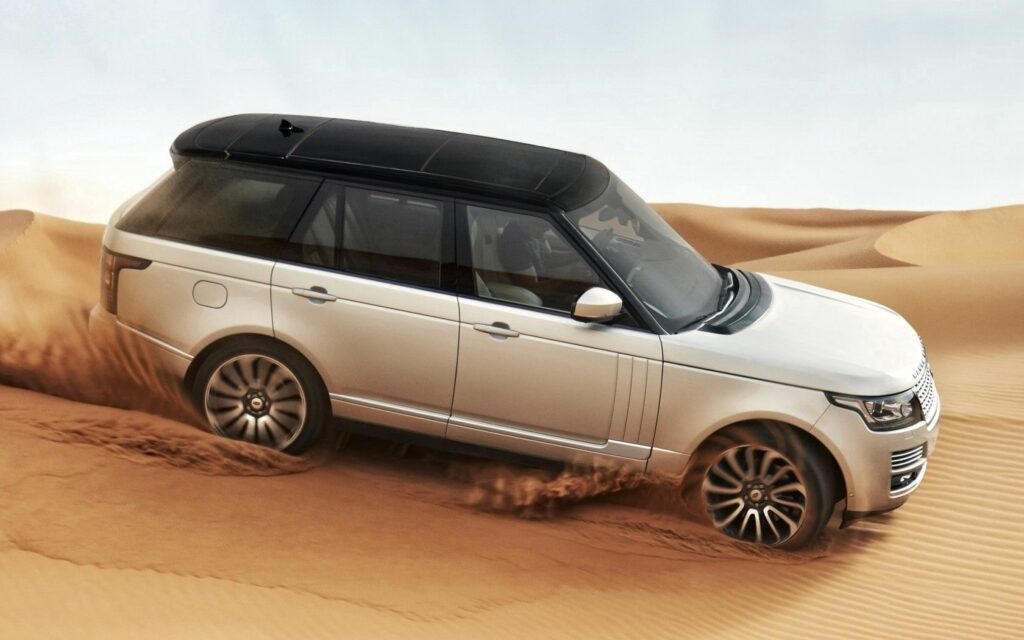 Powerful Land Rover Thrills in Sunlit Desert Dunes: Elegance Unleashed Wallpaper