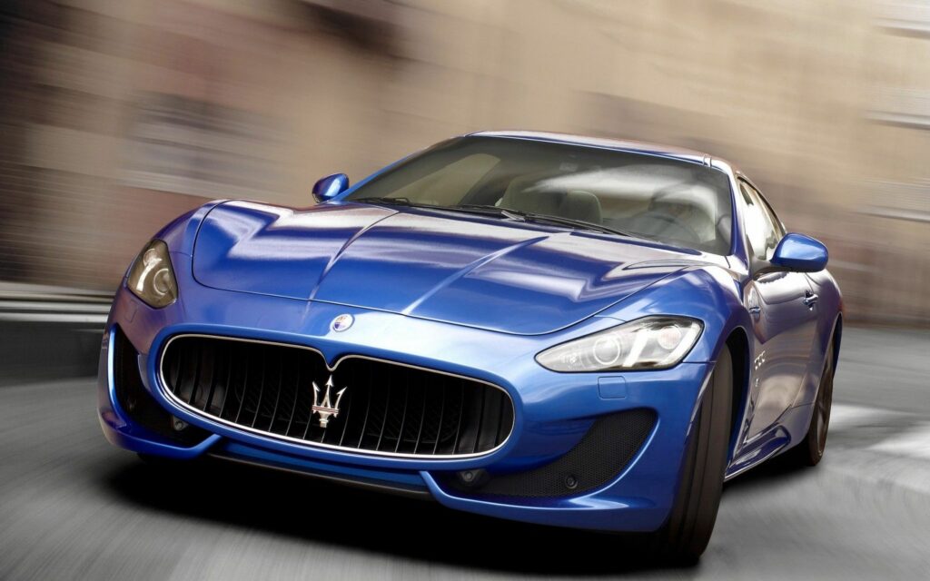 Sleek Maserati Wallpaper: Dynamic Racing Scene & Elegant Design