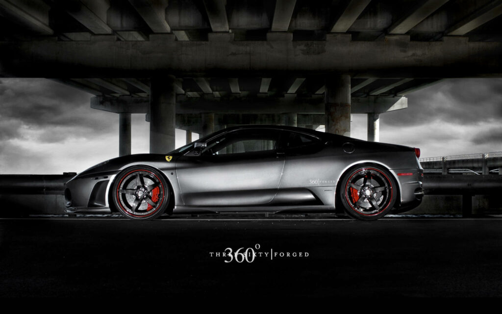 Matte black Ferrari with custom forged wheels under dramatic overpass stylish automotive wallpaper