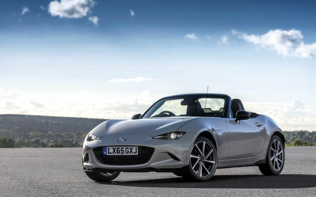 Sleek Mazda MX-5 Spyder Convertible Wallpaper with Scenic Background