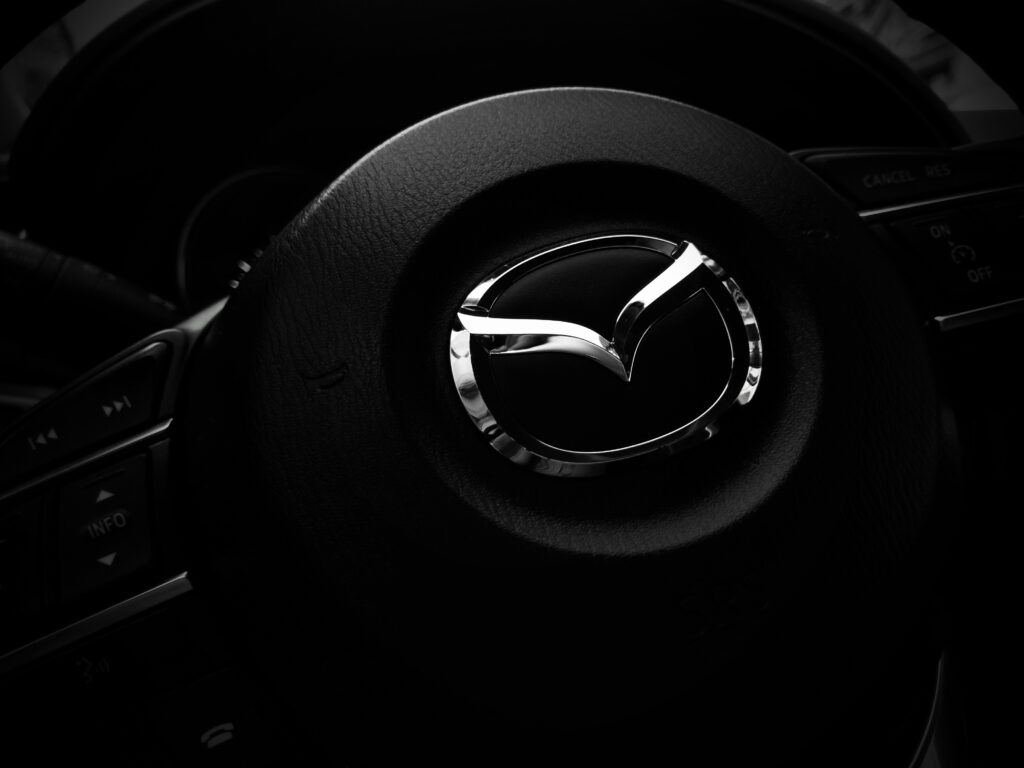 Close-Up Mazda Steering Wheel Wallpaper: Sleek Design & Logo