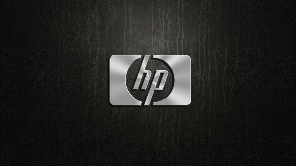 The Industrial Elegance of the HP Laptop: A Majestic Emblem on a Weathered Leather Canvas Wallpaper