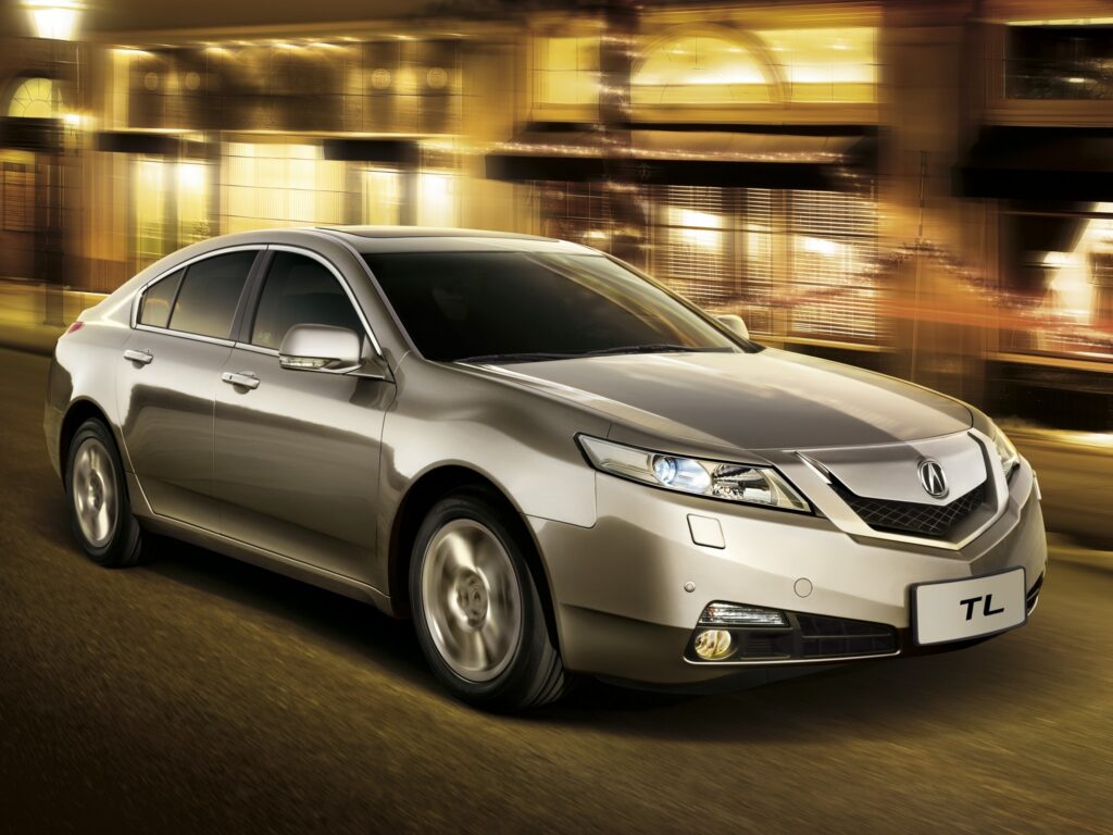 Sleek Metallic Gray Acura TL: Speeding through Urban Nights Wallpaper