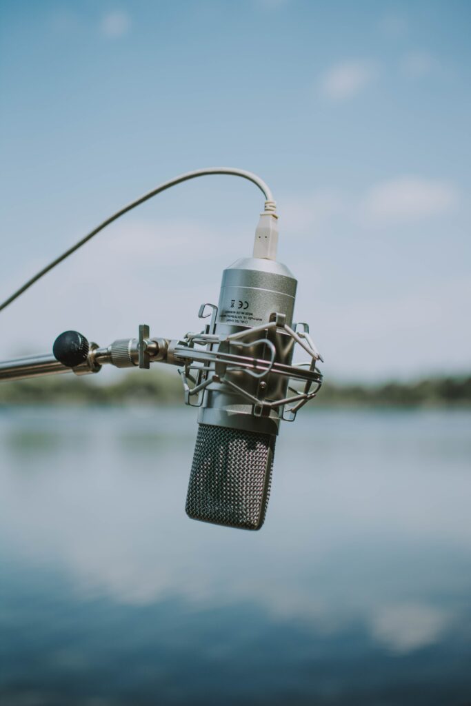 Sleek Metallic Microphone on Stand - Serene Outdoor Wallpaper