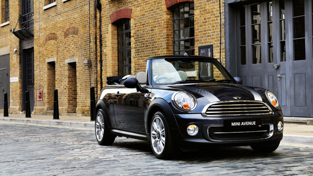 Stylish Jet Black Mini Cooper Wallpaper on Cobblestone Street