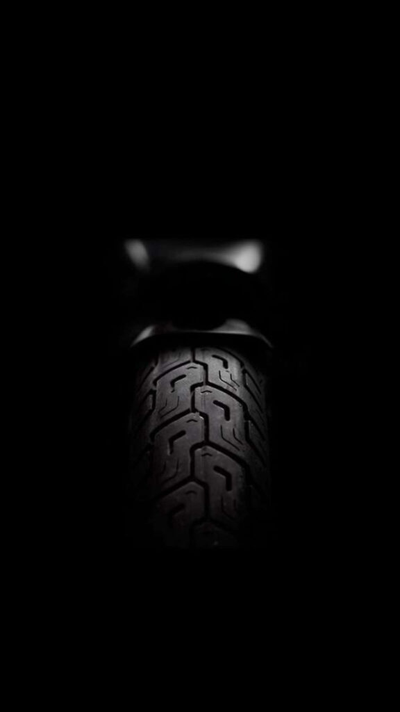 Sleek Minimalist Tire Wallpaper: Intricate Tread on Dark Background