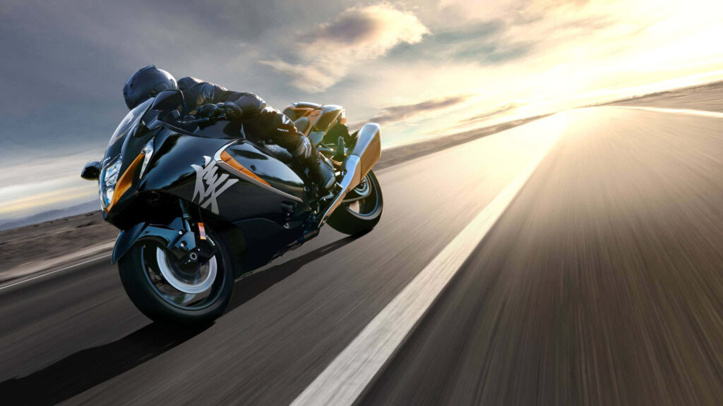 Sleek Motorcycle Wallpaper: Thrilling Sunset Ride on Mountain Road