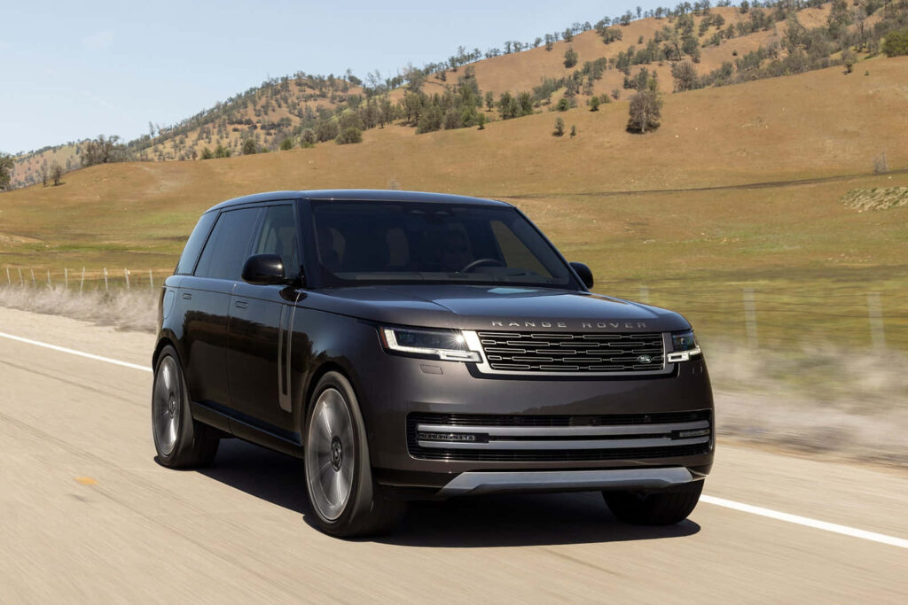 Sleek New Range Rover Vogue Wallpaper: Scenic Road & Open Fields