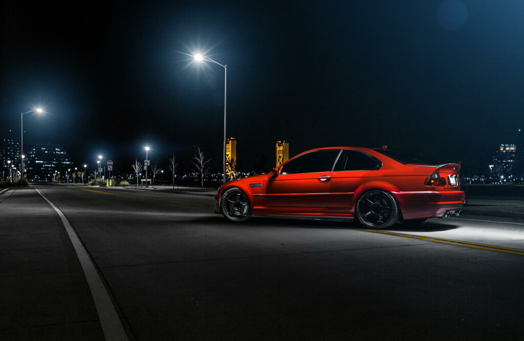 Stunning Night View of Red BMW M3 E46 Wallpaper with Urban Backdrop
