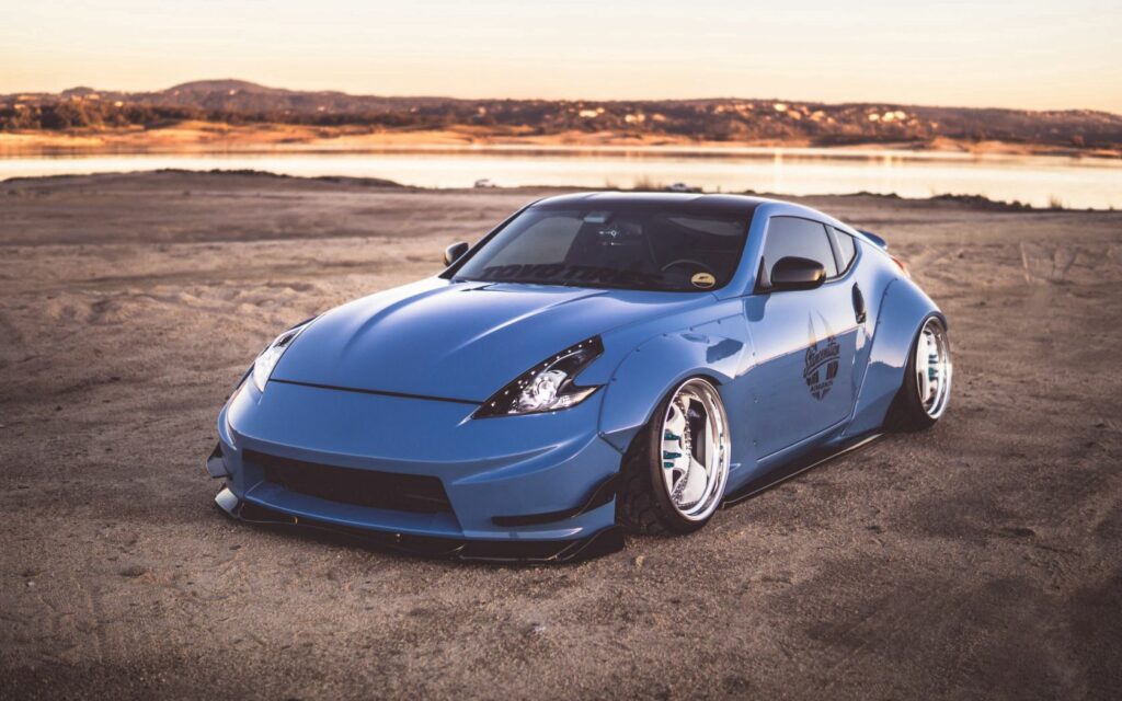 Sleek Nissan 370Z Side View Wallpaper: Sunset Lake Serenity