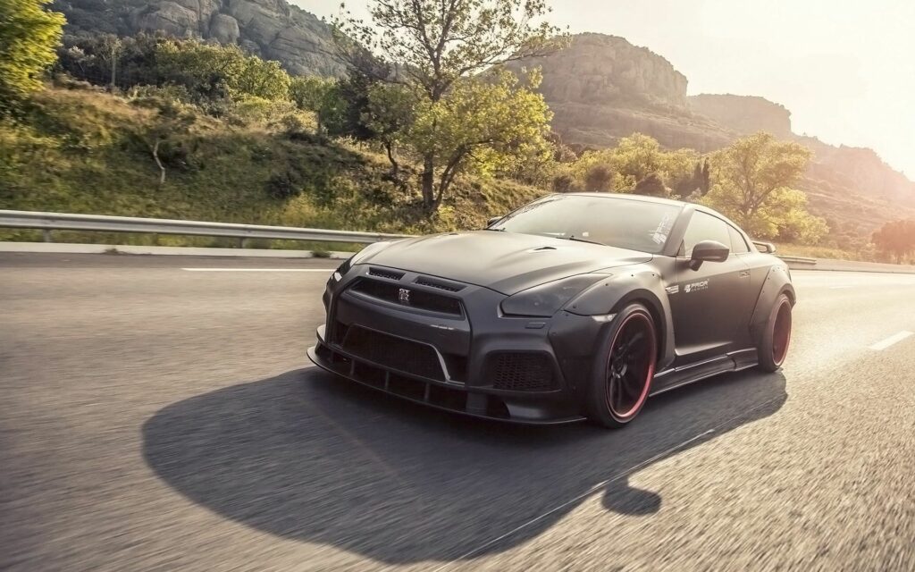 Sleek Nissan GT-R: Expertly Tuned for Dynamic Mountain Highway Racing Wallpaper
