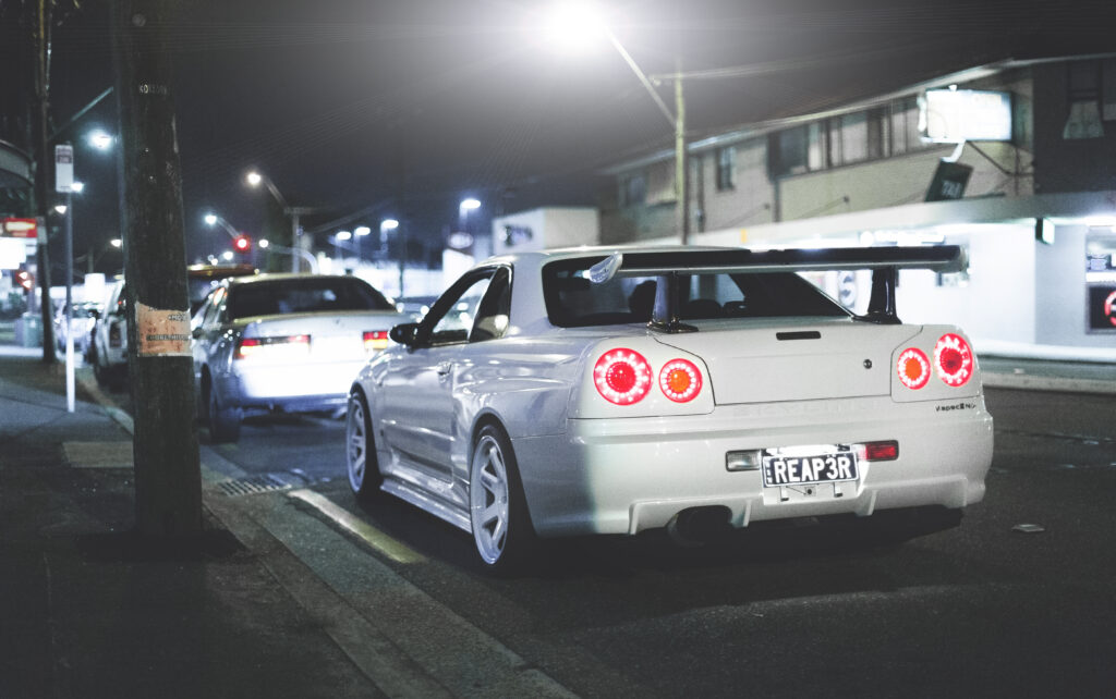 Sleek Nissan Skyline R34 GT-R Rear View Wallpaper in Urban Setting