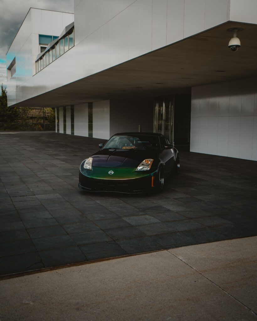 Sleek Nissan Sports Car Front View in Modern Architectural Setting Wallpaper