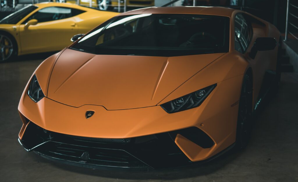 Sleek Orange Sports Car Wallpaper - Front View with Depth